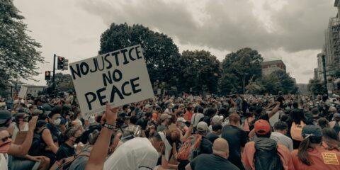 a large crowd of people holding up signs