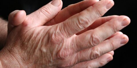 a close up of a person holding their hands together