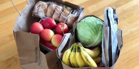 apples and bananas in brown cardboard box