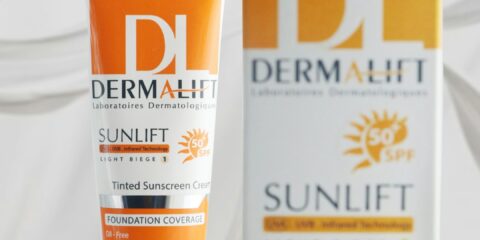 a tube of sunscreen next to a box of sunscreen
