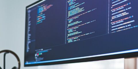 a computer monitor sitting on top of a wooden desk