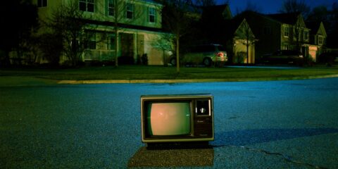 turned off vintage CRT television on road