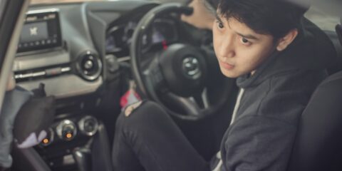 woman in black hoodie sitting on drivers seat