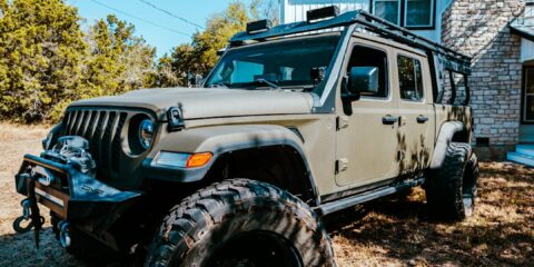 a jeep is parked in front of a house