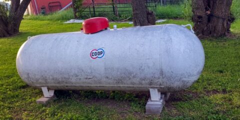 a large tank sitting in the middle of a field