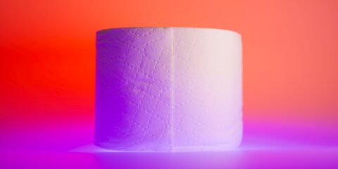 white toilet paper roll on yellow table