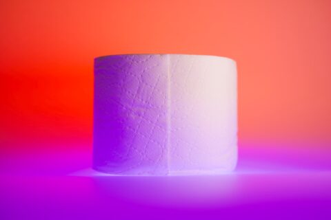 white toilet paper roll on yellow table