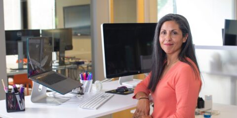 woman in orange long sleeve shirt sitting on chair