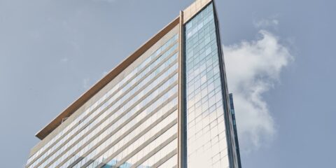 white and blue glass walled building under blue sky during daytime