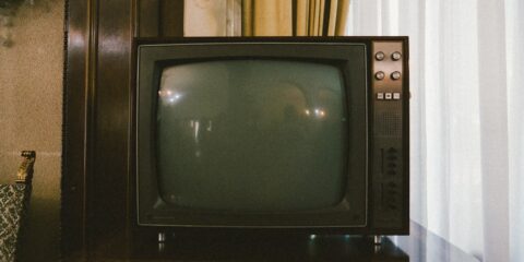 turned-off gray CRT TV on table