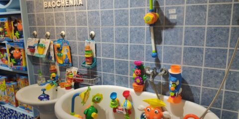 assorted-colored plastic toys hanging on bathtub