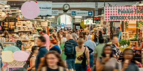 A crowd of people walking through a market