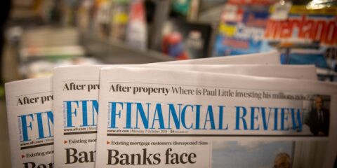 newspapers are stacked on top of each other