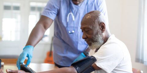 a doctor checking a patient's blood pressure