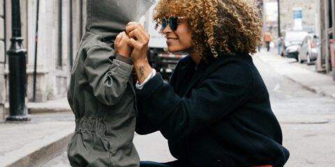 woman holding kid at the street