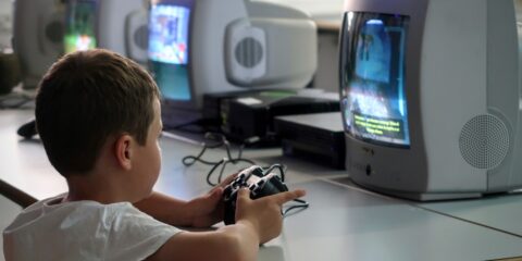 a young boy playing a video game on a nintendo wii