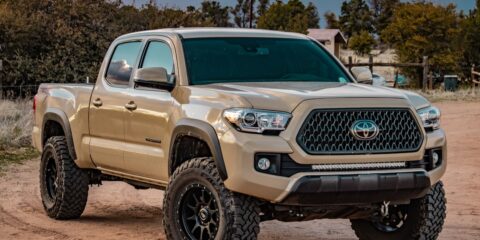 white Toyota crew cab pickup truck on ground