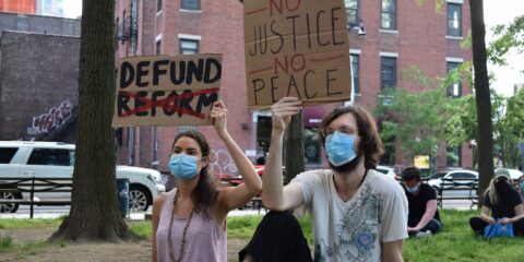 woman in white shirt holding brown wooden board