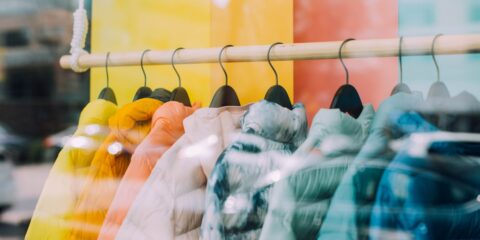 white and black bird on yellow metal wire