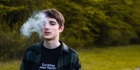 a man with a white cloud of smoke behind him