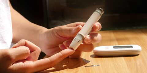 a person sitting at a table with a cell phone