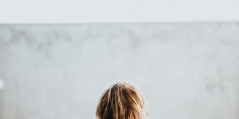half naked man facing wall