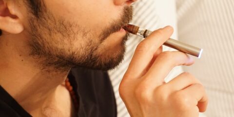 man in black shirt smoking cigarette