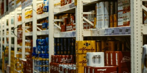 red and white labeled cans on shelf