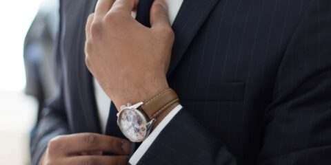 man wearing watch with black suit