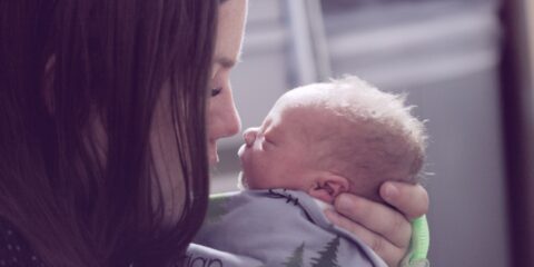 woman kissing baby