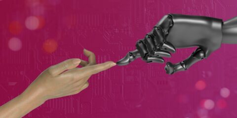 two hands touching each other in front of a pink background