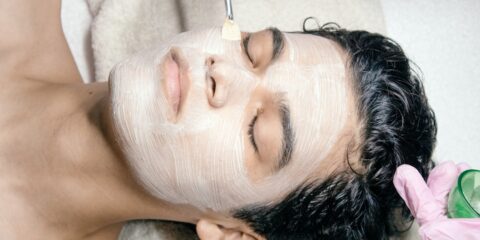 A man getting a facial mask on his face