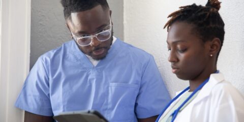 a doctor and a patient looking at a tablet