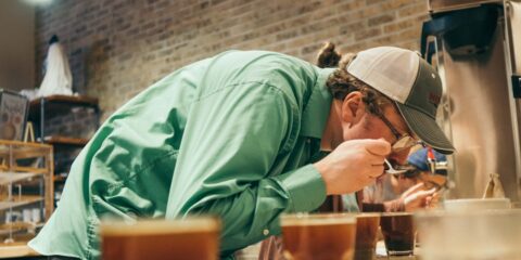 person drinking in a room close-up photography