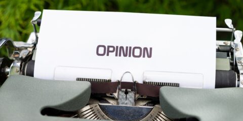 white and black typewriter on green grass during daytime