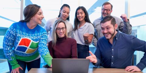 woman in maroon sweater using laptop