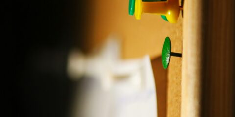 several needle pins on cork board