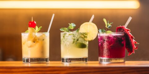 three clear glass cups with juice