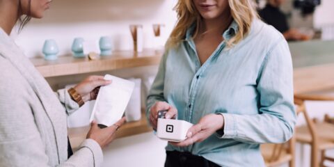 woman holding white pack