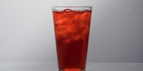 clear drinking glass with brown liquid