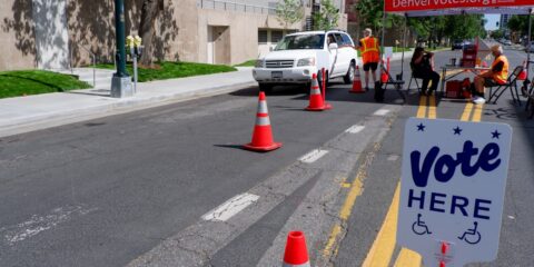 A vote here sign in the middle of a street