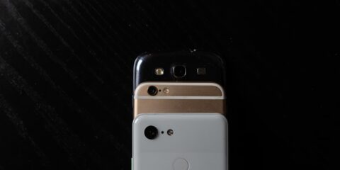 white iphone 4 on black textile