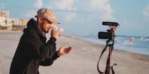 man in black jacket holding camera during daytime