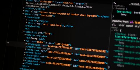 turned on monitor displaying programming language