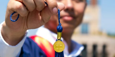 a man wearing a graduation cap and gown