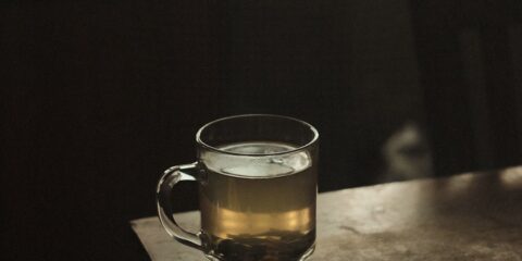 clear glass mug with brown liquid