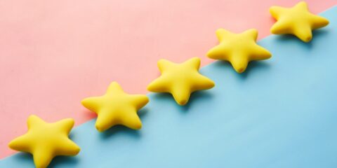 Unmoderated Task – Your Feedback (Nationwide) – Earn $60 a row of yellow stars sitting on top of a blue and pink surface